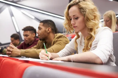 female-student-taking-notes-in-a-university-lectur-2024-10-20-11-07-56-utc